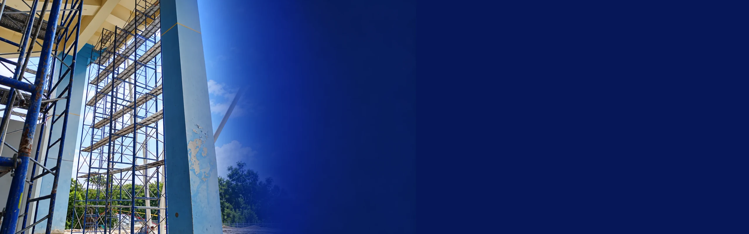 Andamio azul con escaleras de acceso en una obra
